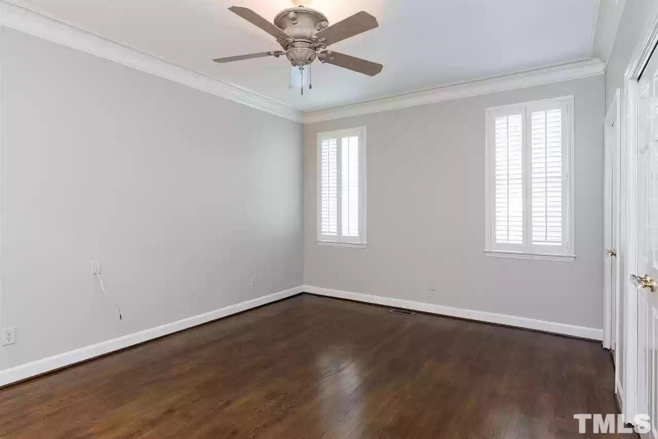 2625 Ashland Street Raleigh, NC 27608 - Photo 7 of 26 an empty room with wooden floor and windows