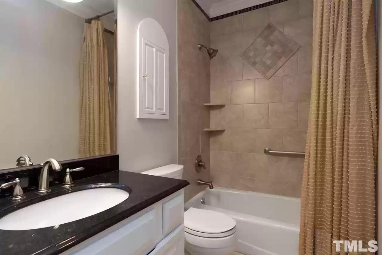 2625 Ashland Street Raleigh, NC 27608 - Photo 8 of 26 a bathroom with a granite countertop sink toilet and shower