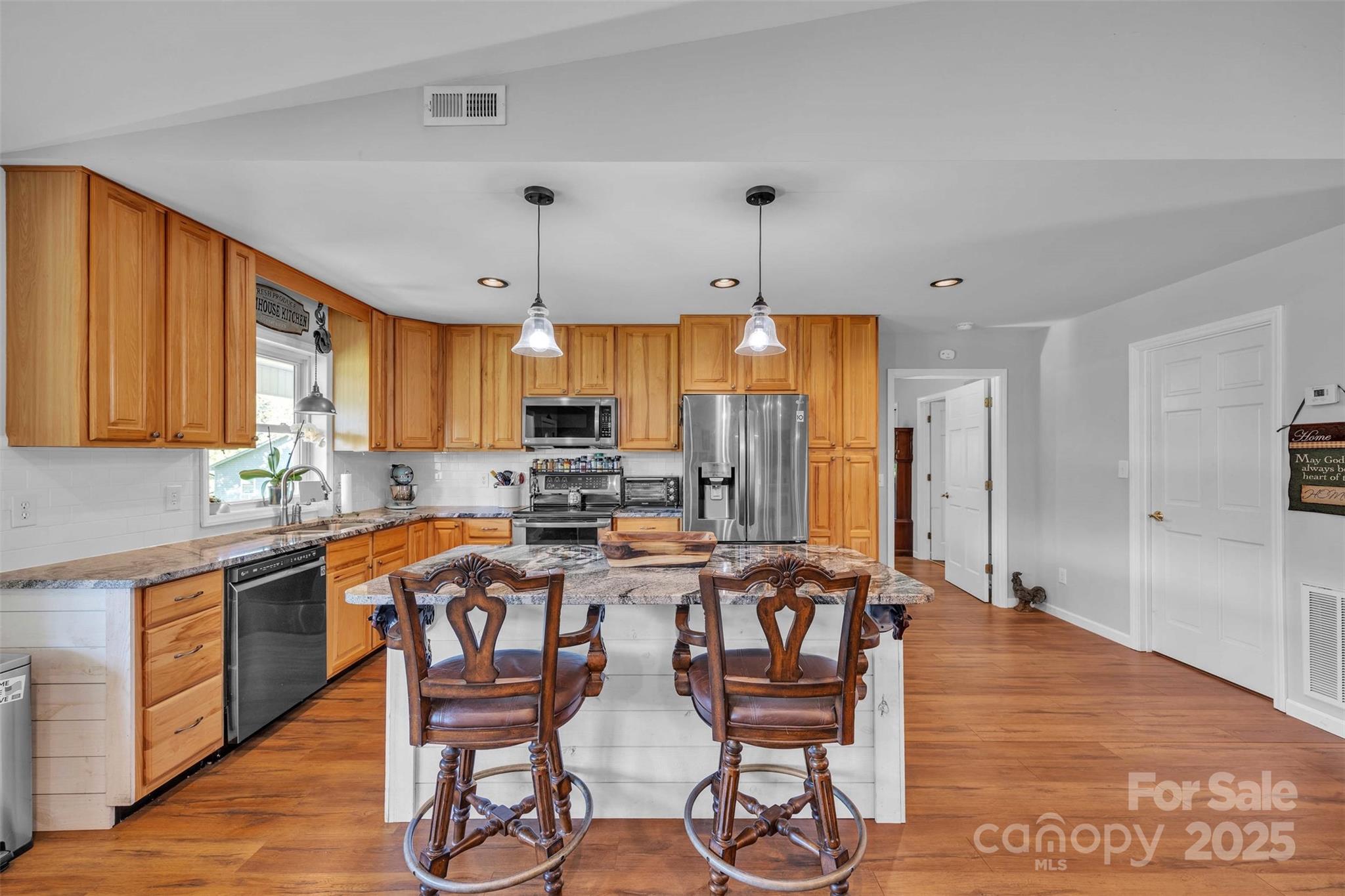 5158 Jenkins Road Morganton, NC 28655 - Photo 14 of 40 a kitchen with stainless steel appliances a table chairs refrigerator and cabinets