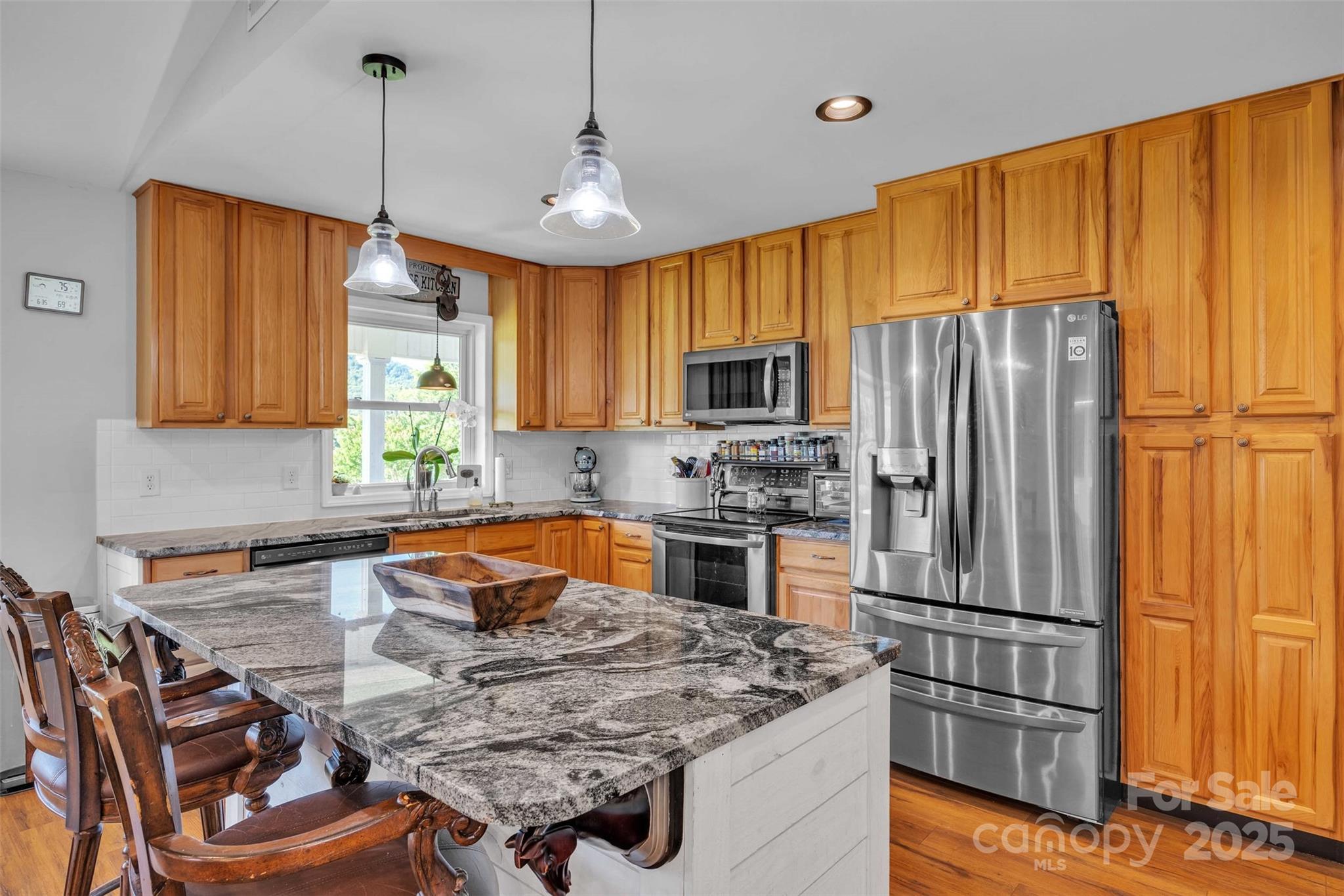5158 Jenkins Road Morganton, NC 28655 - Photo 15 of 40 a kitchen with stainless steel appliances granite countertop a refrigerator a sink dishwasher a stove and a microwave