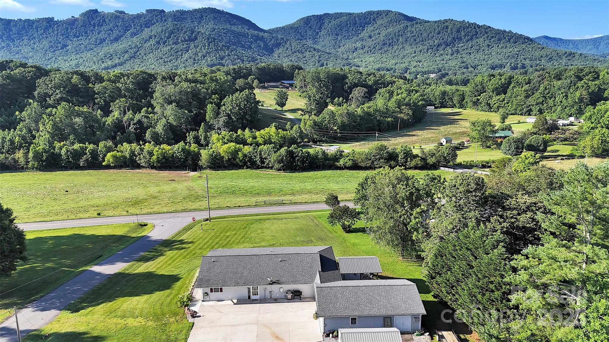 5158 Jenkins Road Morganton, NC 28655 - Photo 3 of 40 an aerial view of a house with garden space and mountain view in back