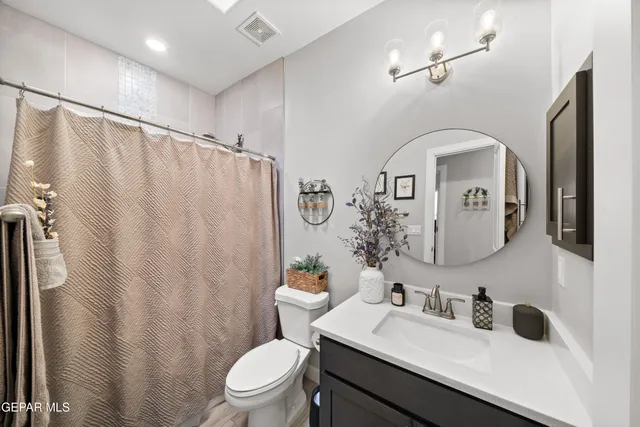 a bedroom with a large bed and a wooden floor