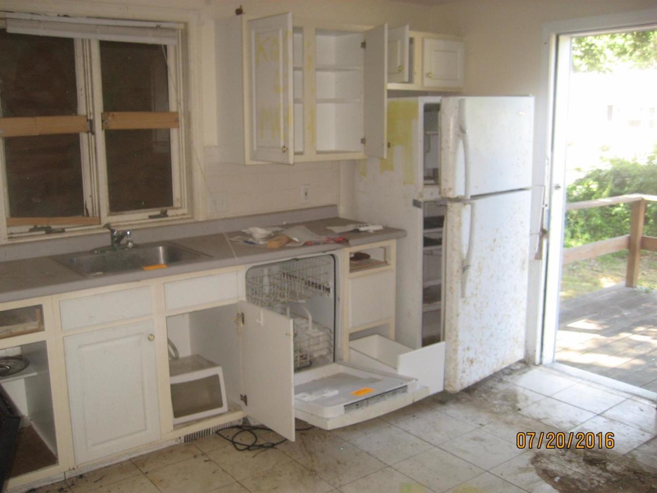 57 Lewis Road Hyannis, MA 02601 - Photo 3 of 3 a kitchen with white cabinets and refrigerator
