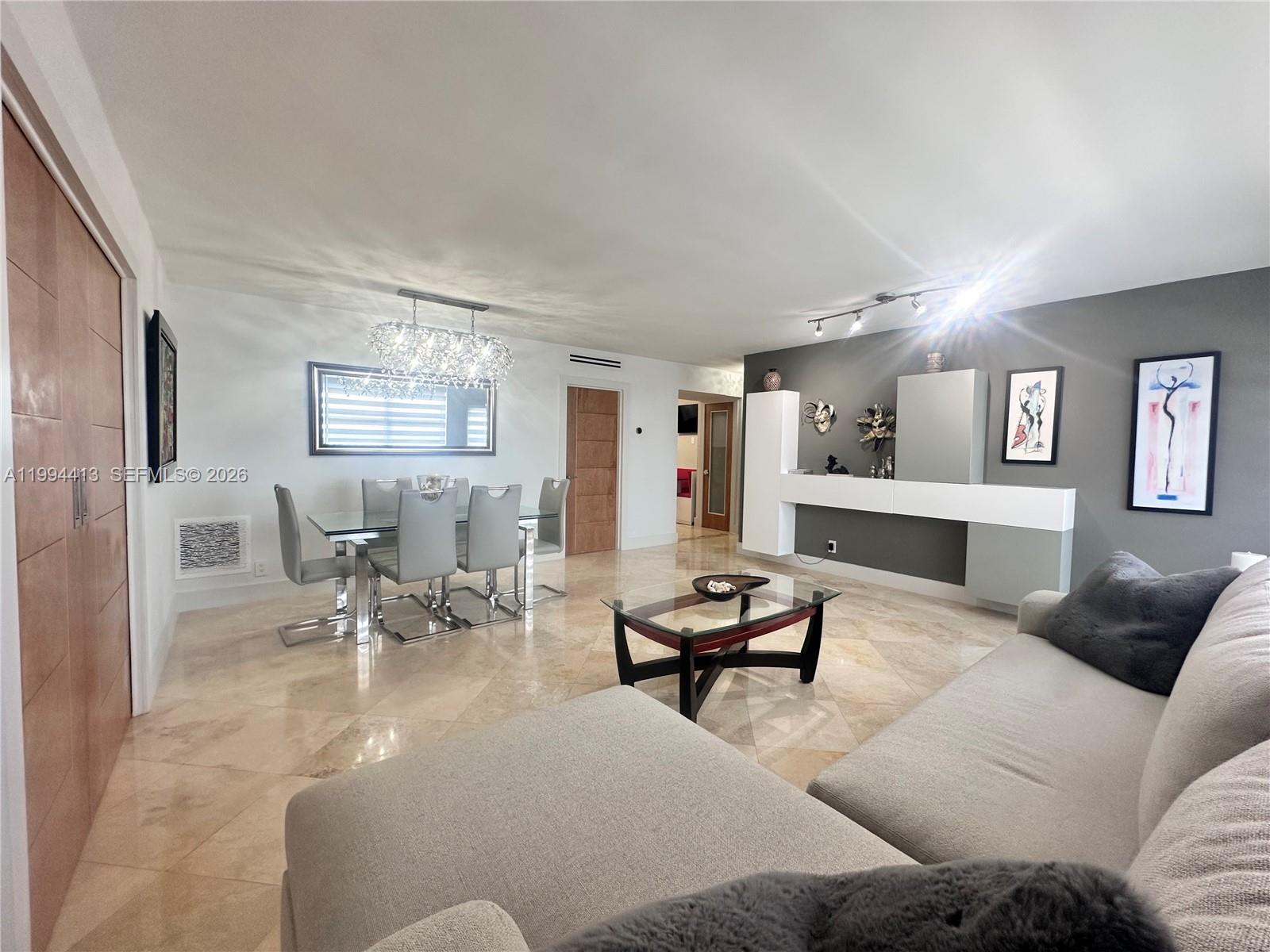 9225 Collins Avenue, Unit 1111 Surfside, FL 33154 - Photo 12 of 54 a living room with furniture and wooden floor