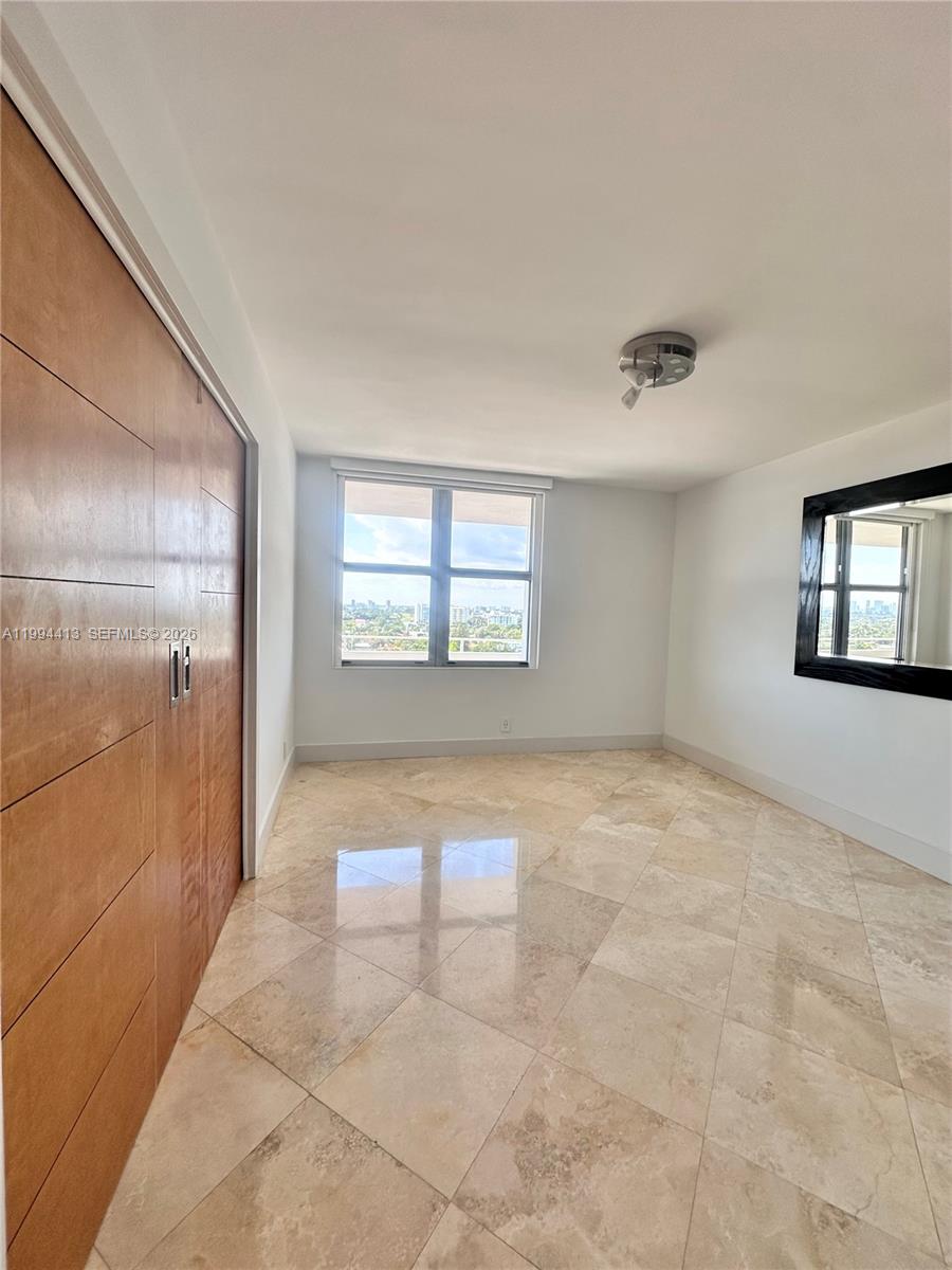9225 Collins Avenue, Unit 1111 Surfside, FL 33154 - Photo 16 of 54 a view of an empty room with a window
