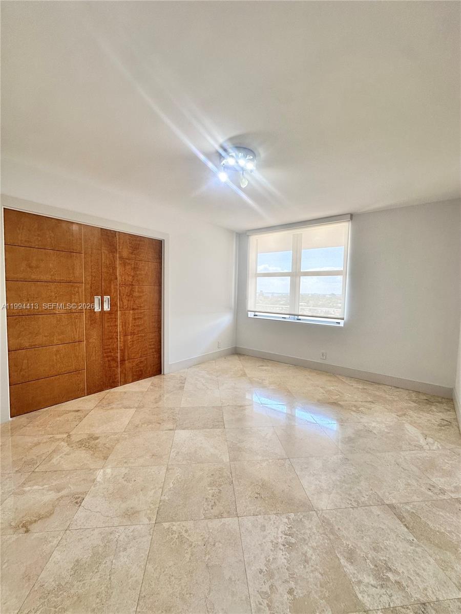 9225 Collins Avenue, Unit 1111 Surfside, FL 33154 - Photo 17 of 54 a view of an empty room with a window