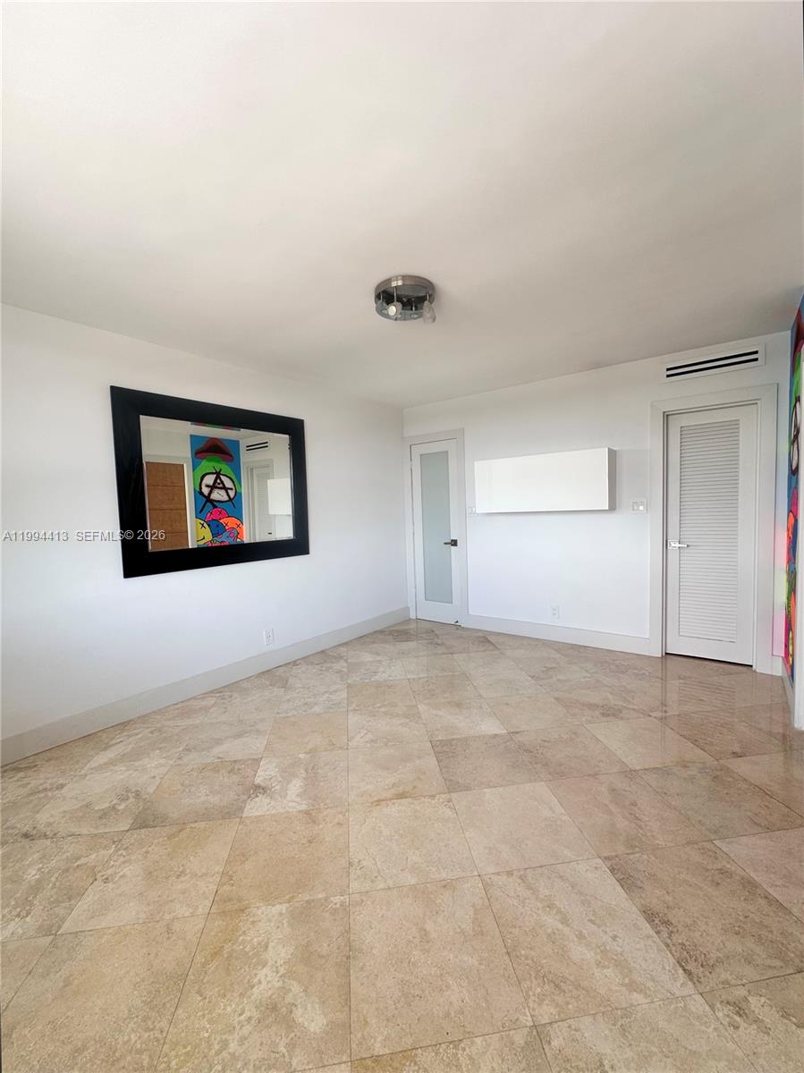 9225 Collins Avenue, Unit 1111 Surfside, FL 33154 - Photo 18 of 54 a view of a livingroom with an empty space