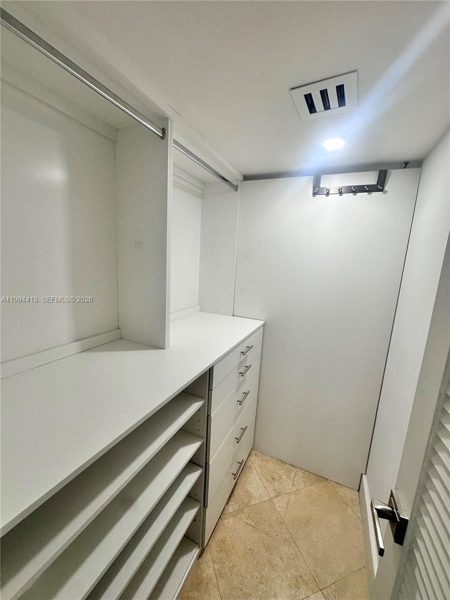 9225 Collins Avenue, Unit 1111 Surfside, FL 33154 - Photo 22 of 54 a bathroom with a sink and a shower
