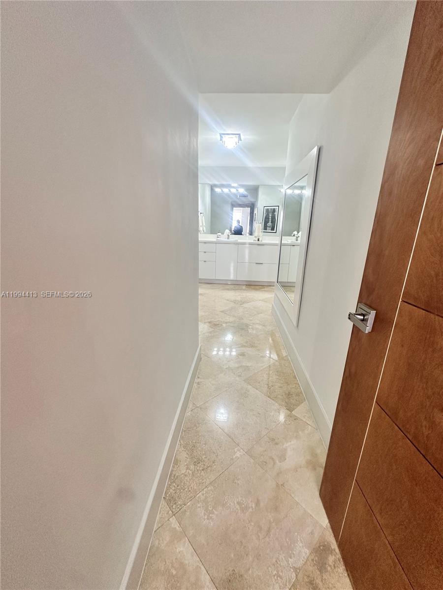 9225 Collins Avenue, Unit 1111 Surfside, FL 33154 - Photo 23 of 54 a view of a hallway