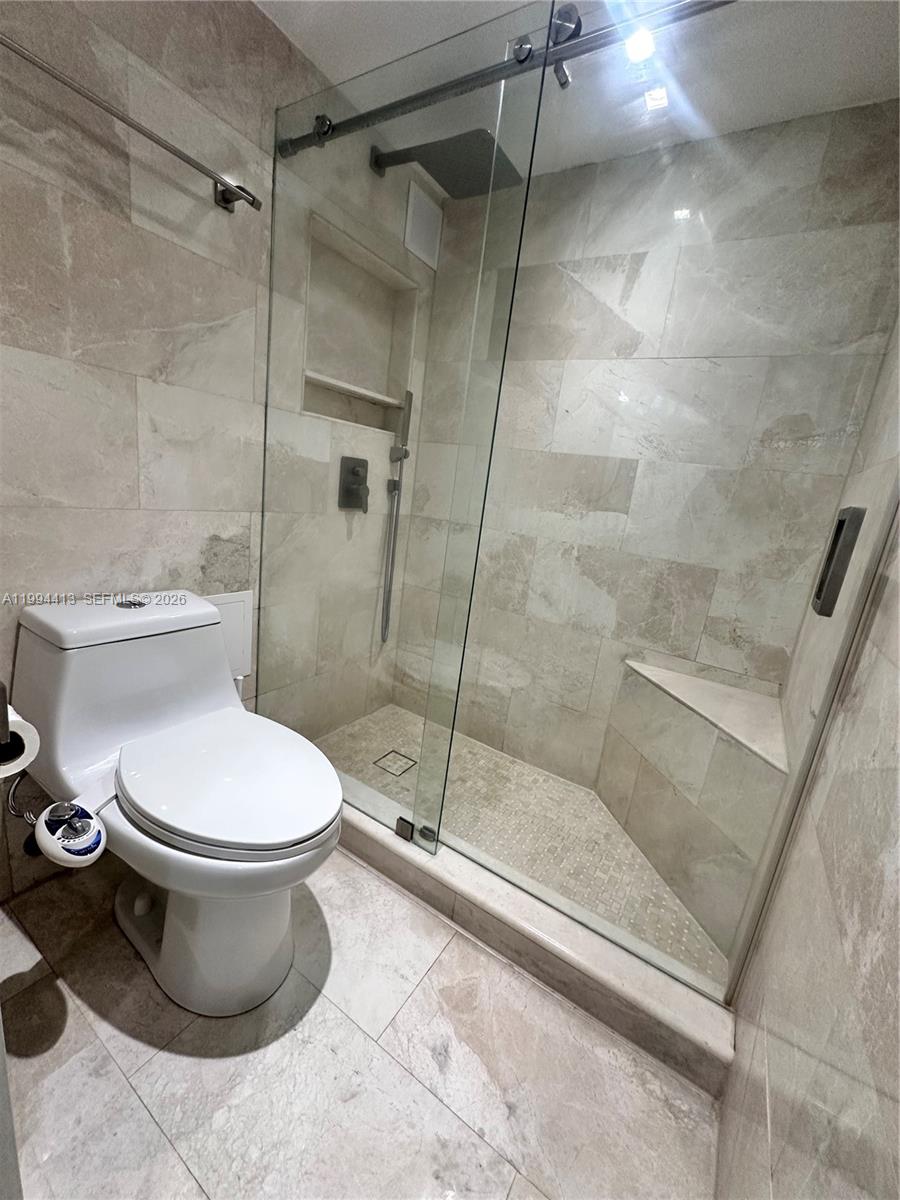 9225 Collins Avenue, Unit 1111 Surfside, FL 33154 - Photo 30 of 54 a bathroom with a toilet and a shower