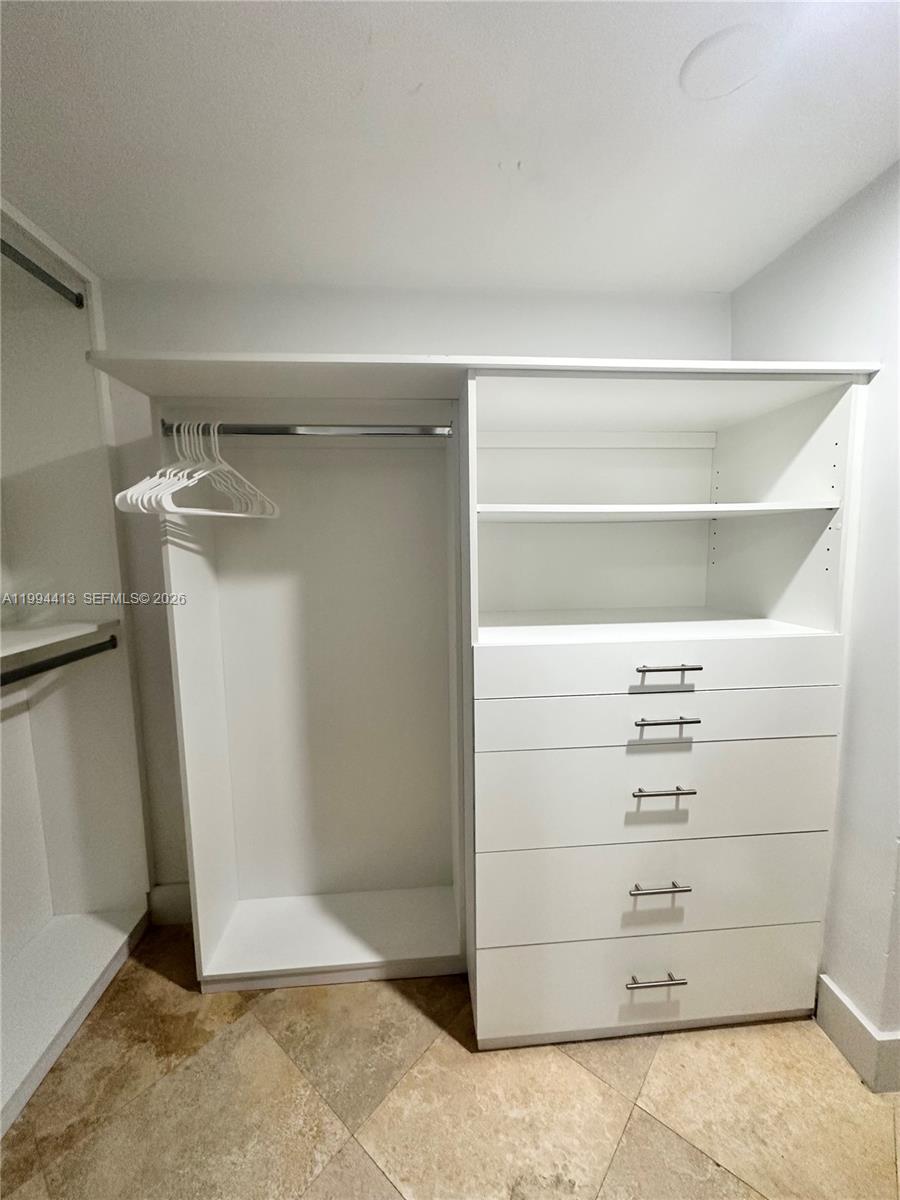 9225 Collins Avenue, Unit 1111 Surfside, FL 33154 - Photo 32 of 54 a view of walk in closet with empty racks