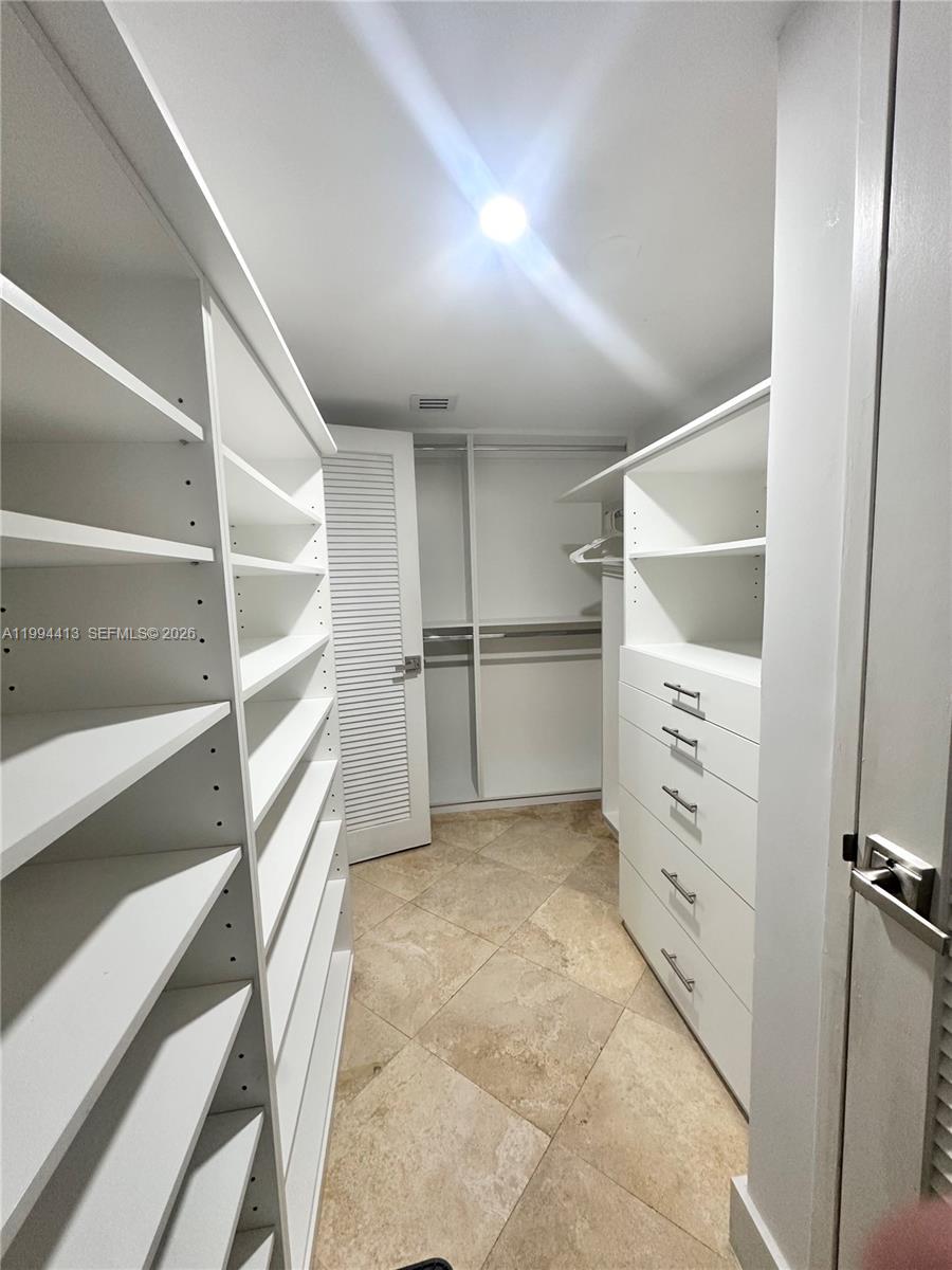 9225 Collins Avenue, Unit 1111 Surfside, FL 33154 - Photo 33 of 54 a view of an empty walk in closet