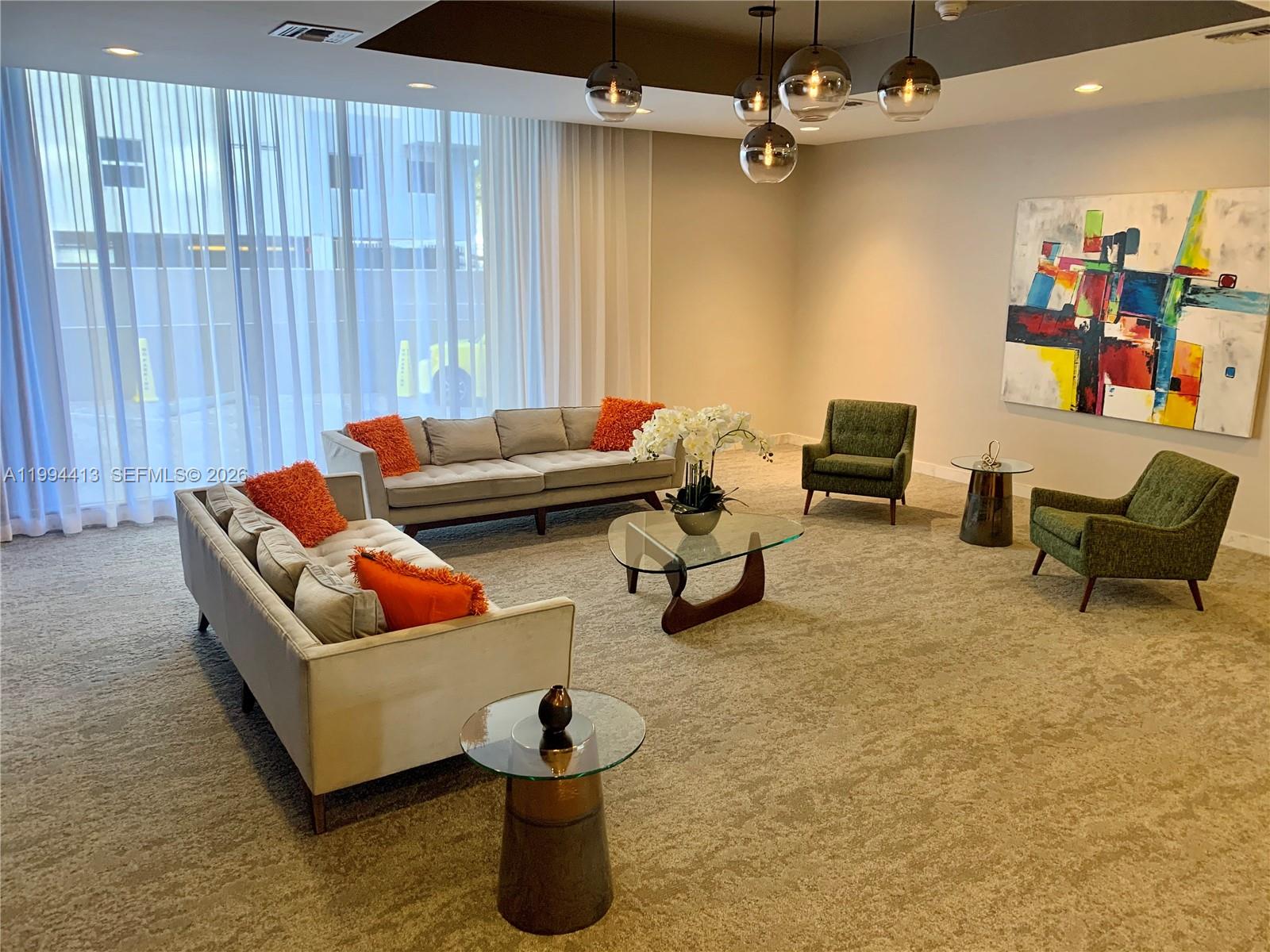 9225 Collins Avenue, Unit 1111 Surfside, FL 33154 - Photo 41 of 54 a living room with furniture and a ceiling fan