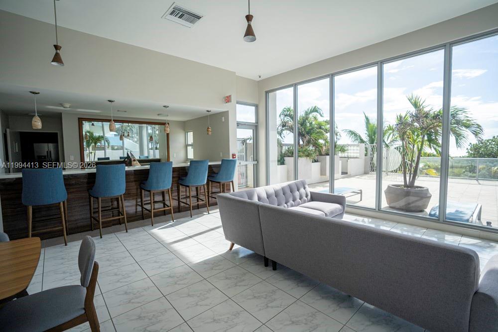 9225 Collins Avenue, Unit 1111 Surfside, FL 33154 - Photo 42 of 54 a living room with furniture and a large window