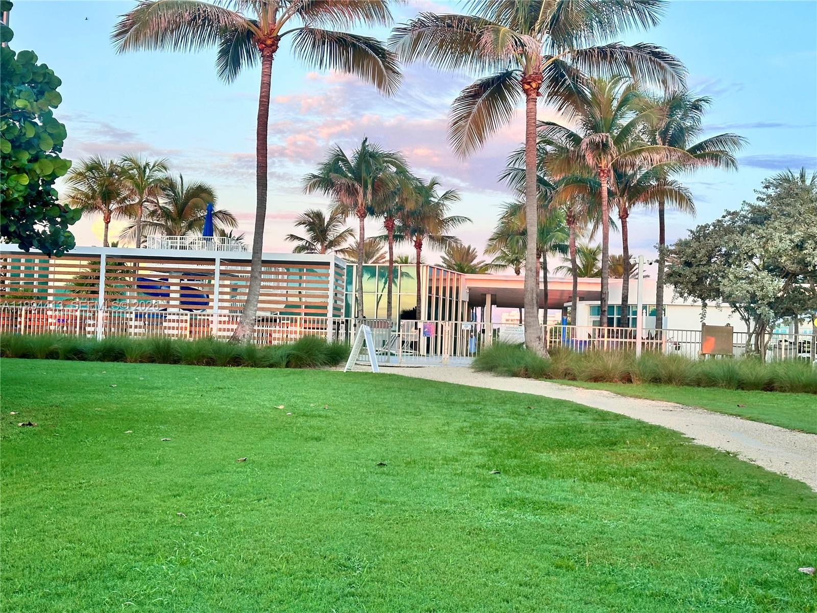 9225 Collins Avenue, Unit 1111 Surfside, FL 33154 - Photo 51 of 54 a view of a park with palm trees