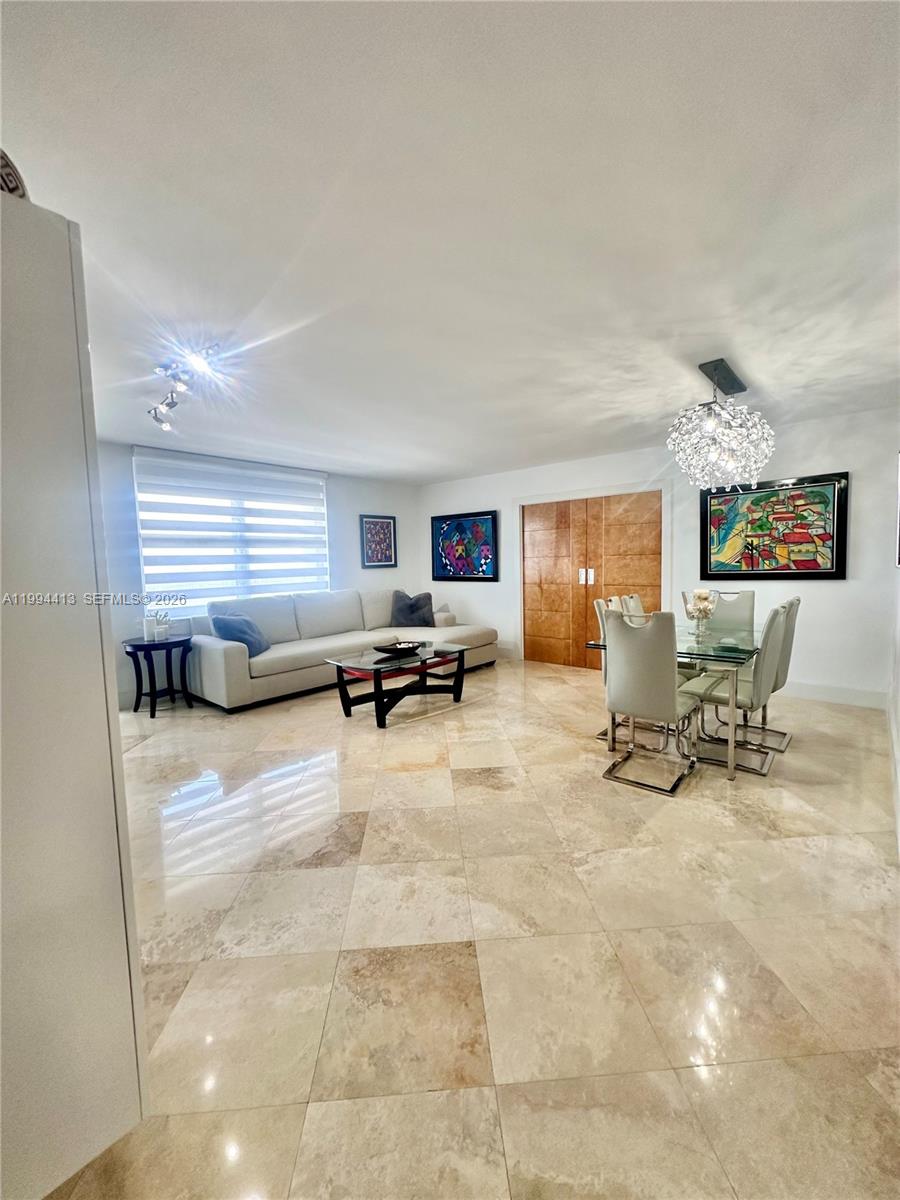 9225 Collins Avenue, Unit 1111 Surfside, FL 33154 - Photo 7 of 54 a living room with furniture and a window