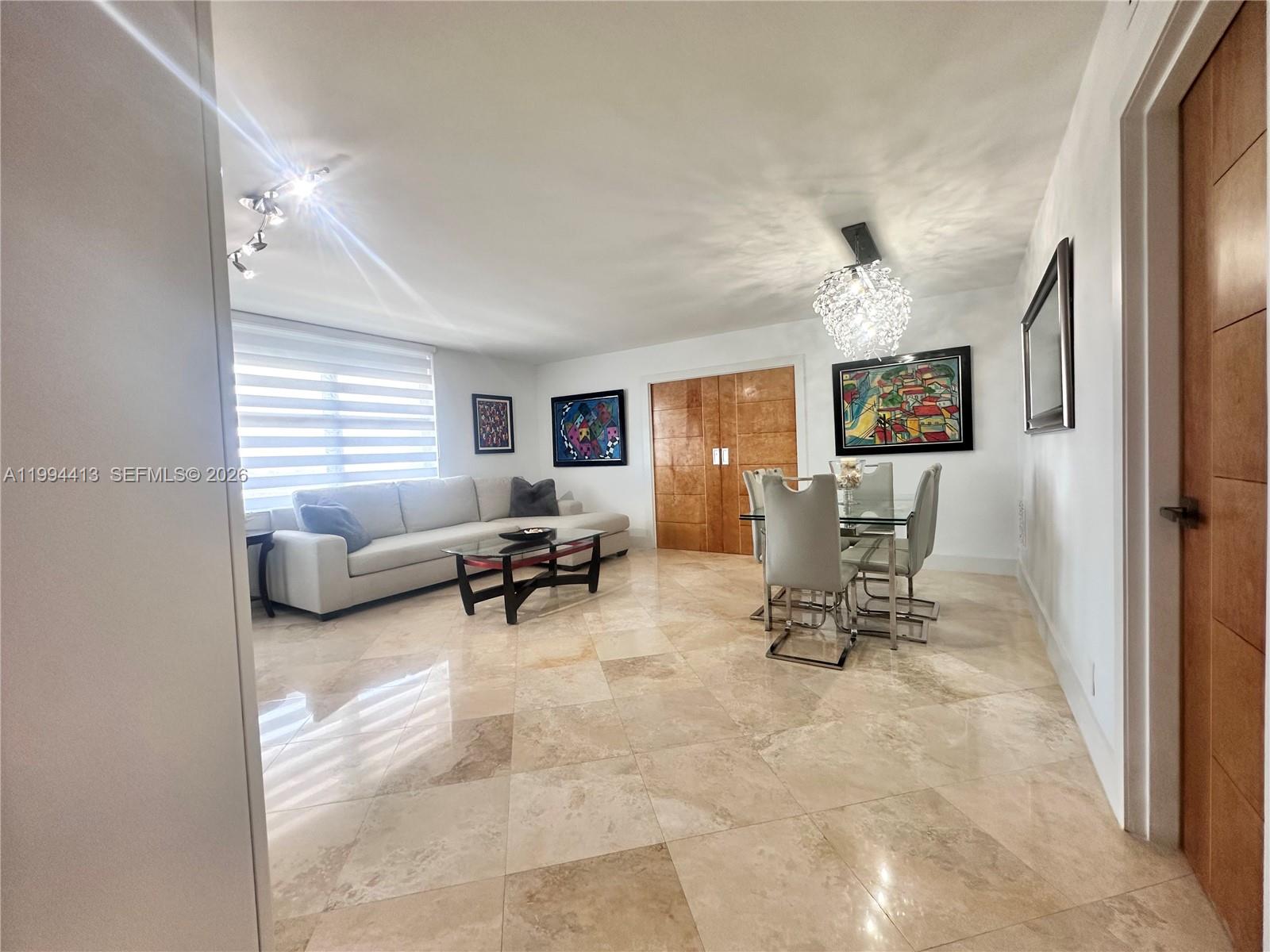 9225 Collins Avenue, Unit 1111 Surfside, FL 33154 - Photo 8 of 54 a view of a livingroom with furniture and a window