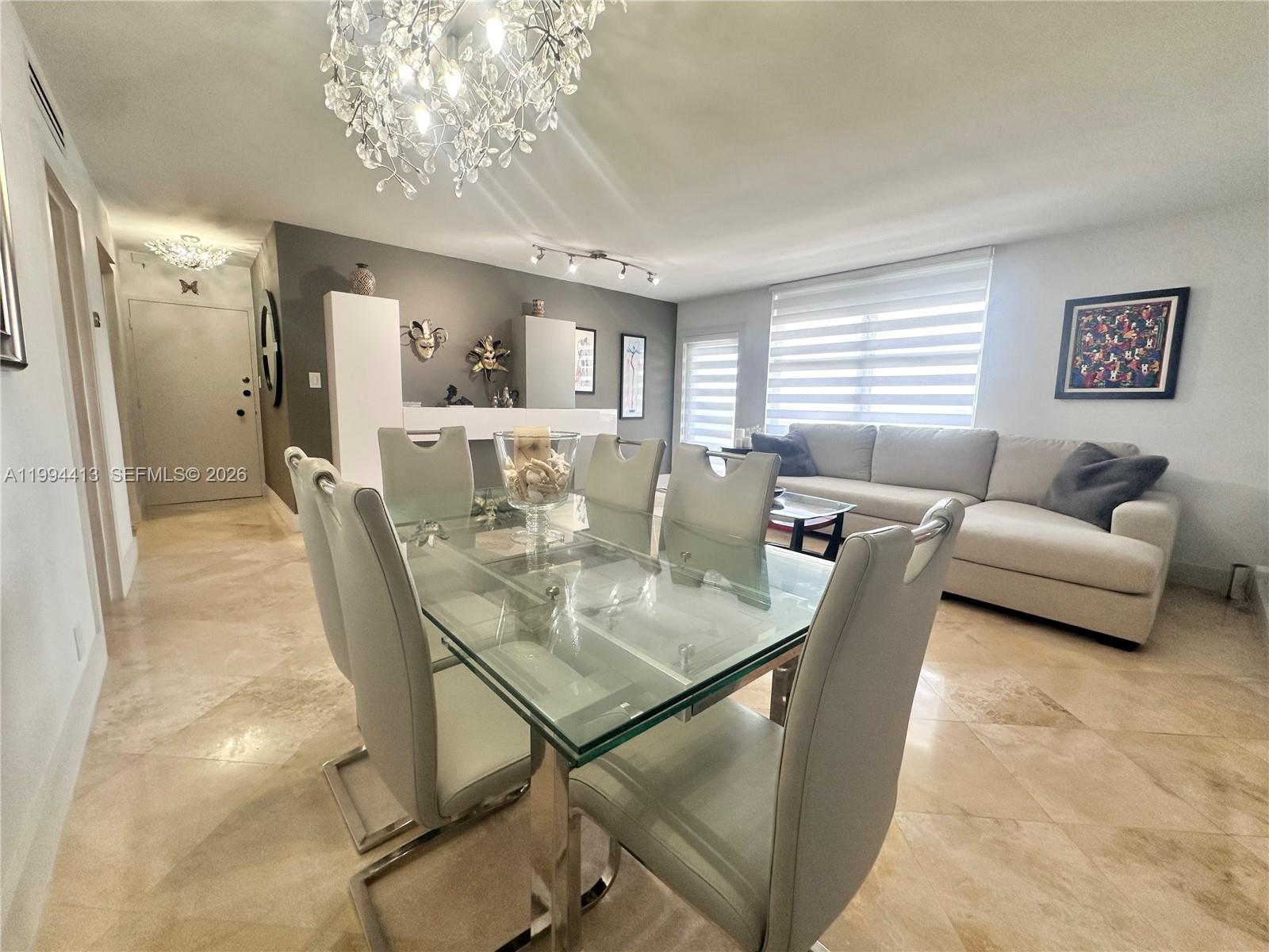 9225 Collins Avenue, Unit 1111 Surfside, FL 33154 - Photo 9 of 54 a view of a dining room with furniture