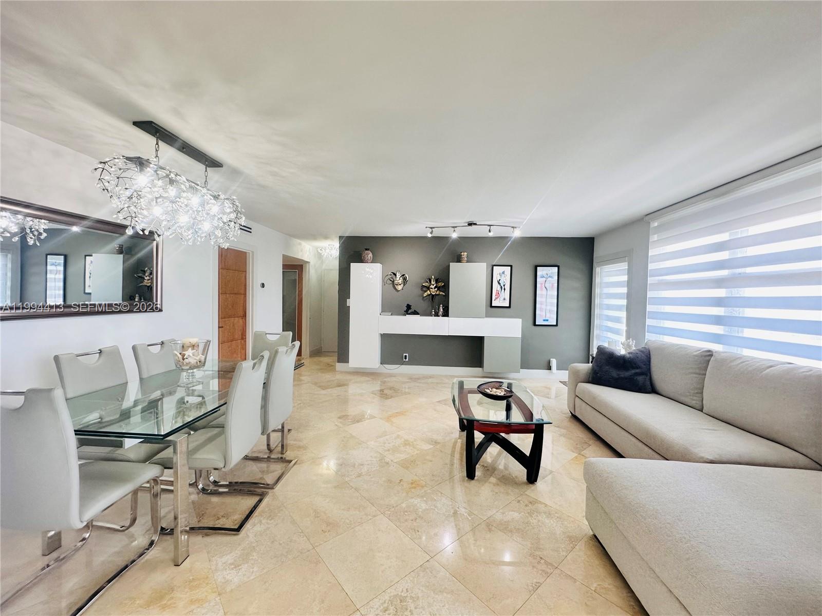 9225 Collins Avenue, Unit 1111 Surfside, FL 33154 - Photo 10 of 54 a living room with furniture and wooden floor