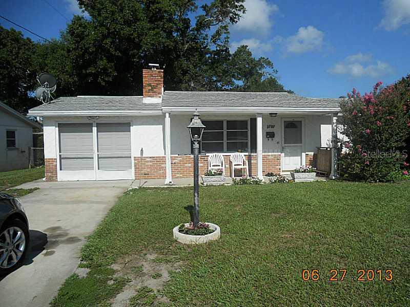 3707 Hendrix Street New Port Richey, FL 34652 - Photo 1 of 1 a front view of a house with a garden and yard