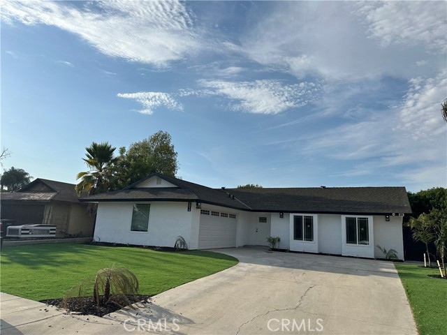 2014 Iris Way Hemet, CA 92545 - Photo 1 of 10 a front view of a house with a garden and yard