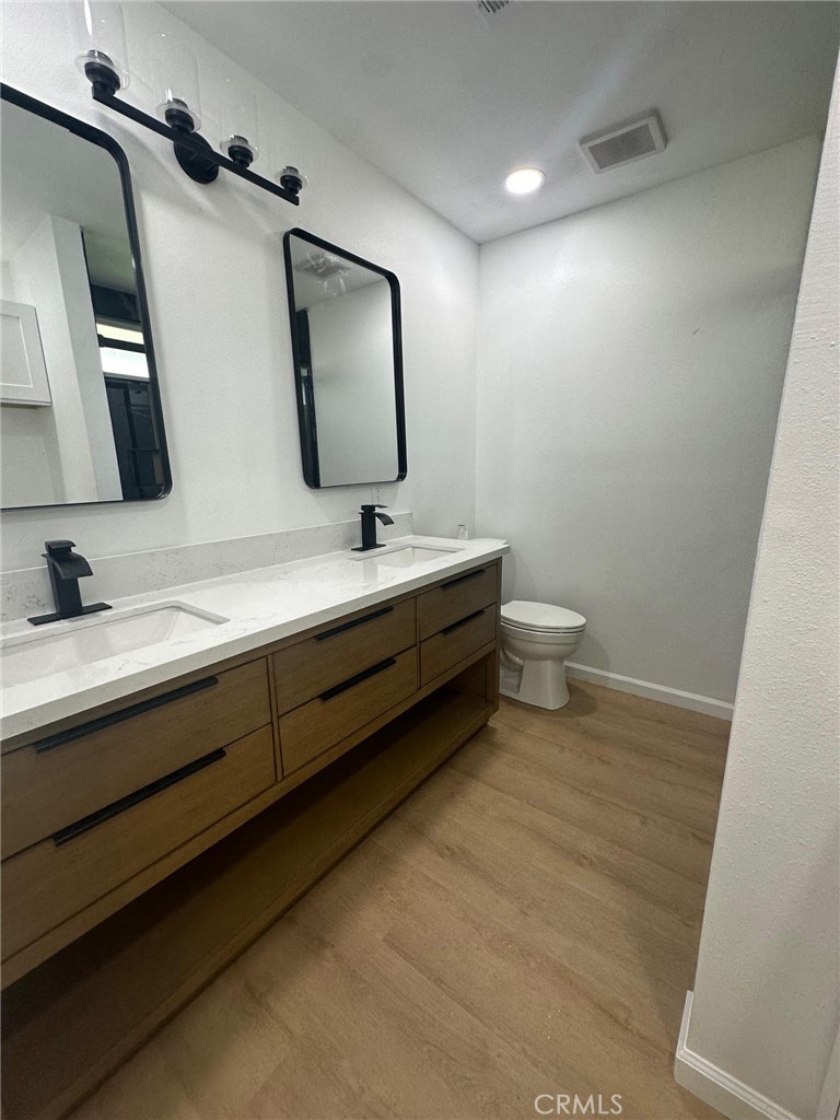 2014 Iris Way Hemet, CA 92545 - Photo 3 of 5 a bathroom with a double vanity sink and a mirror