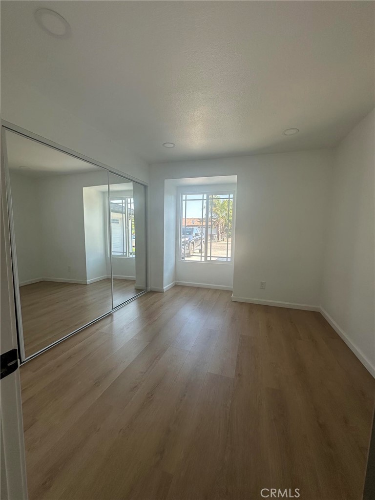 2014 Iris Way Hemet, CA 92545 - Photo 7 of 10 an empty room with wooden floor and windows