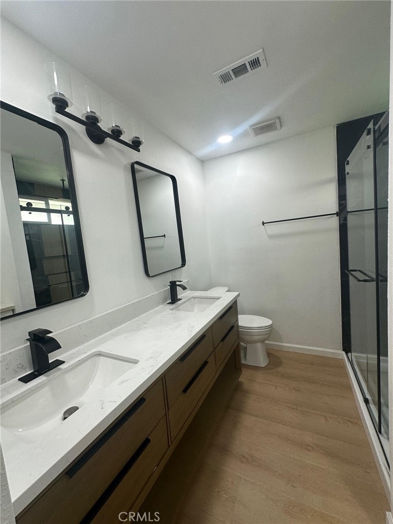 2014 Iris Way Hemet, CA 92545 - Photo 8 of 10 a bathroom with a double vanity sink toilet and mirror