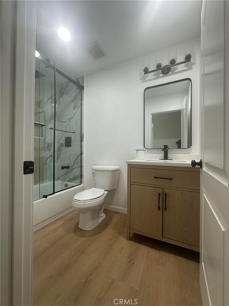 2014 Iris Way Hemet, CA 92545 - Photo 9 of 10 a bathroom with a toilet a sink and mirror