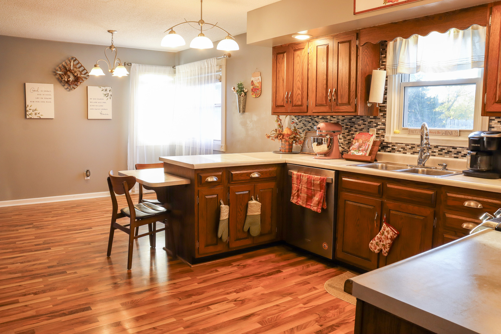102 South Jackson Street Morrison, IL 61270 - Photo 10 of 29 a kitchen with stainless steel appliances granite countertop a sink wooden cabinets dining table and chairs