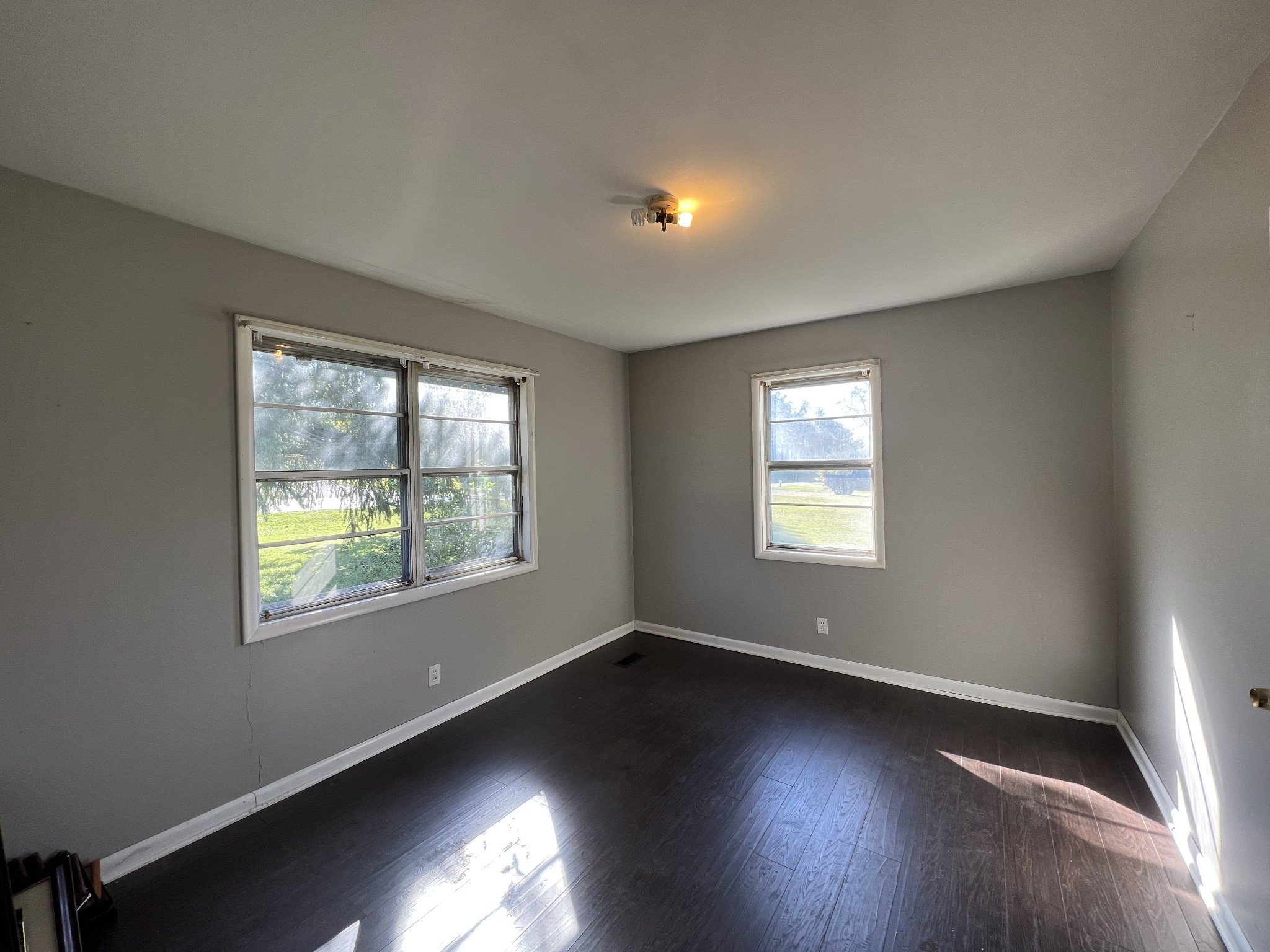1255 Main Street Pleasant View, TN 37146 - Photo 9 of 14 a view of an empty room with wooden floor and a window