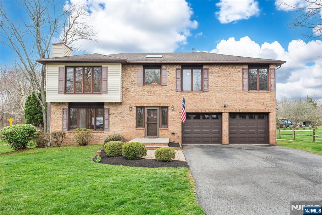 1 Old Timber Court Roxbury Township, NJ 07847 - Photo 2 of 34 a front view of a house with a yard and garage