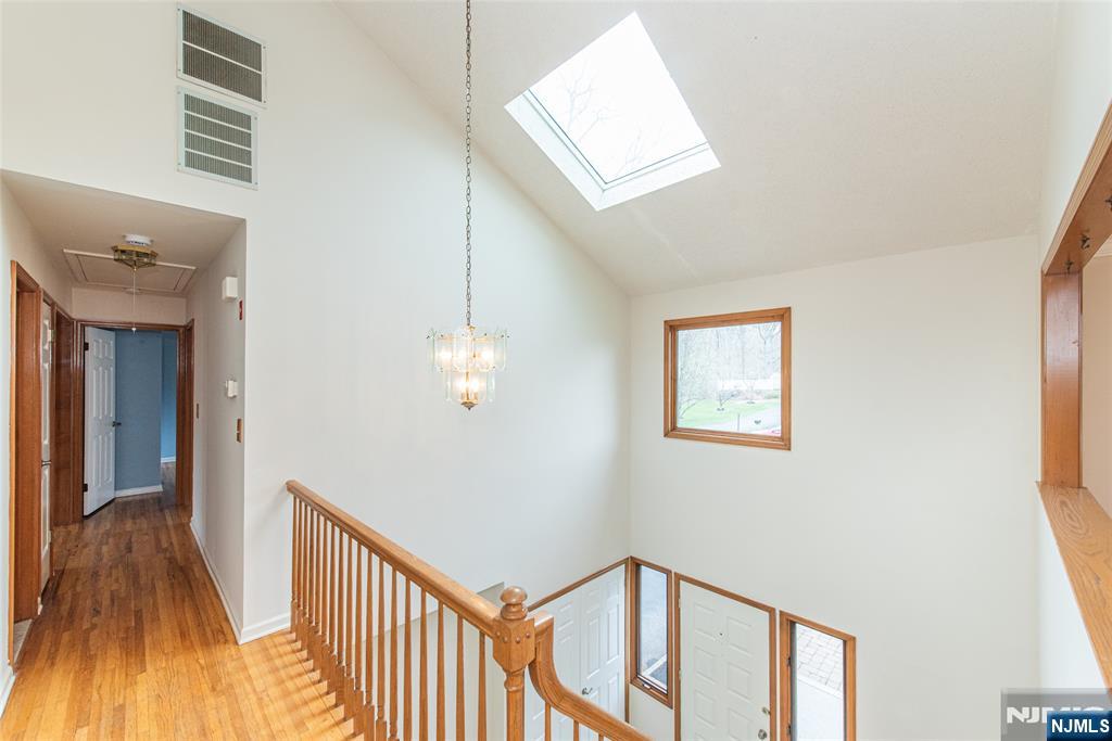 1 Old Timber Court Roxbury Township, NJ 07847 - Photo 24 of 34 a view of a hallway with wooden floor and staircase