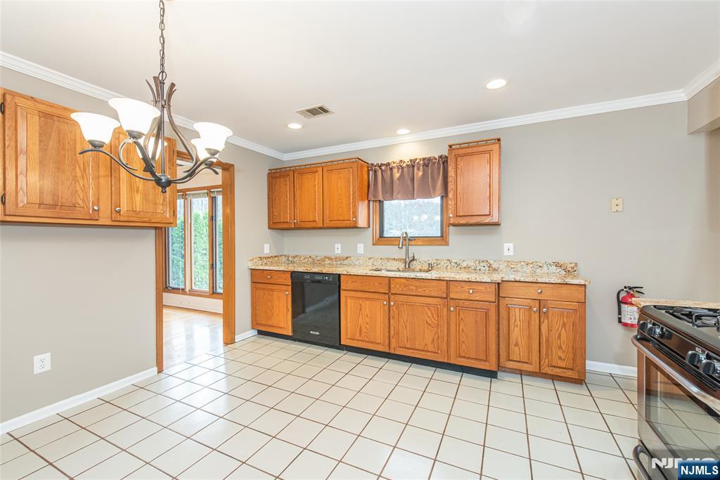 1 Old Timber Court Roxbury Township, NJ 07847 - Photo 9 of 34 a kitchen with stainless steel appliances granite countertop a sink and a refrigerator