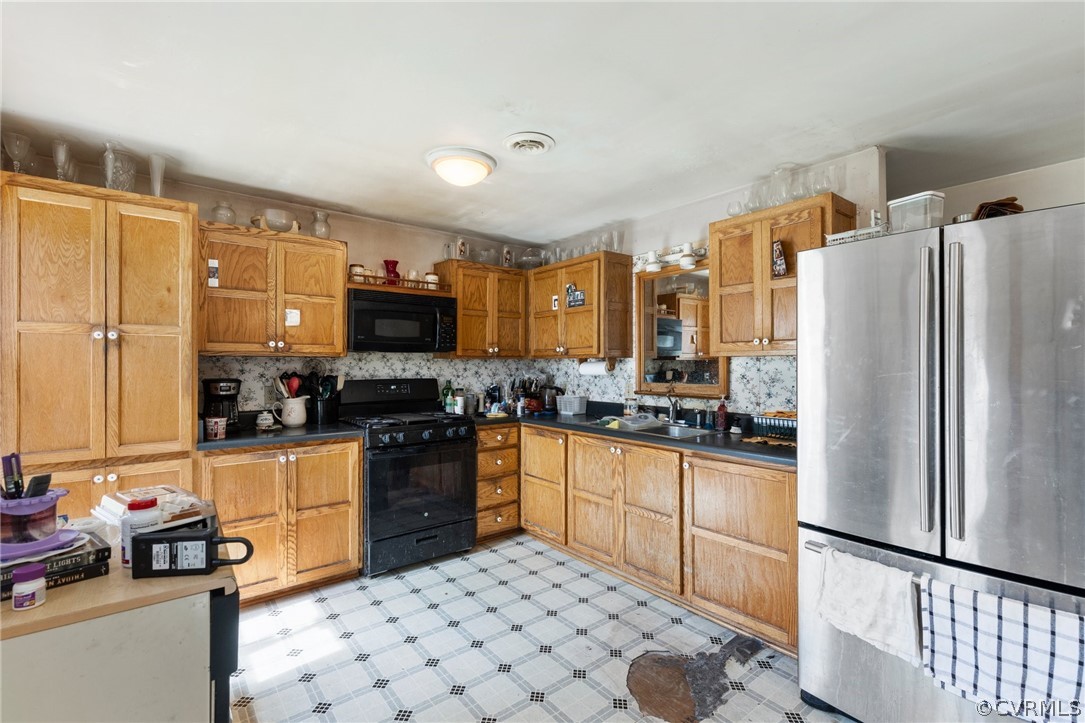 8442 Wheeling Road Mechanicsville, VA 23116 - Photo 6 of 23 a kitchen with granite countertop a refrigerator stove top oven and sink