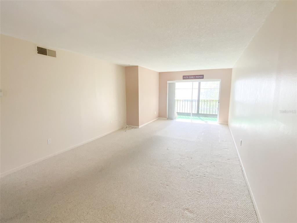 1370 Heather Ridge Boulevard, Unit 204 Dunedin, FL 34698 - Photo 12 of 37 a view of an empty room with a window