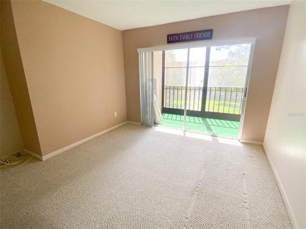 1370 Heather Ridge Boulevard, Unit 204 Dunedin, FL 34698 - Photo 13 of 37 a view of an empty room with a window
