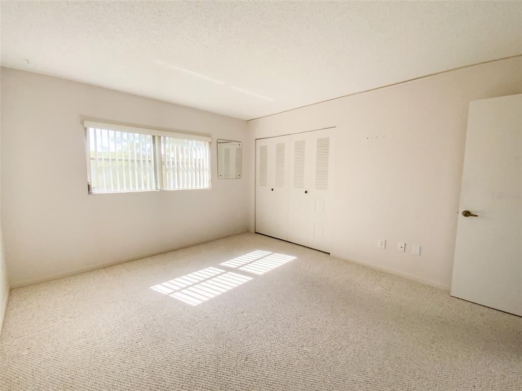 1370 Heather Ridge Boulevard, Unit 204 Dunedin, FL 34698 - Photo 16 of 37 an empty room with windows