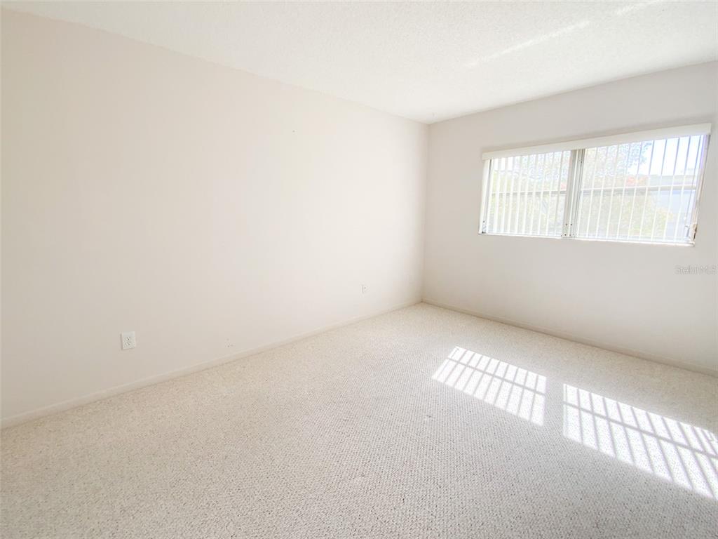 1370 Heather Ridge Boulevard, Unit 204 Dunedin, FL 34698 - Photo 17 of 37 a view of an empty room with a window