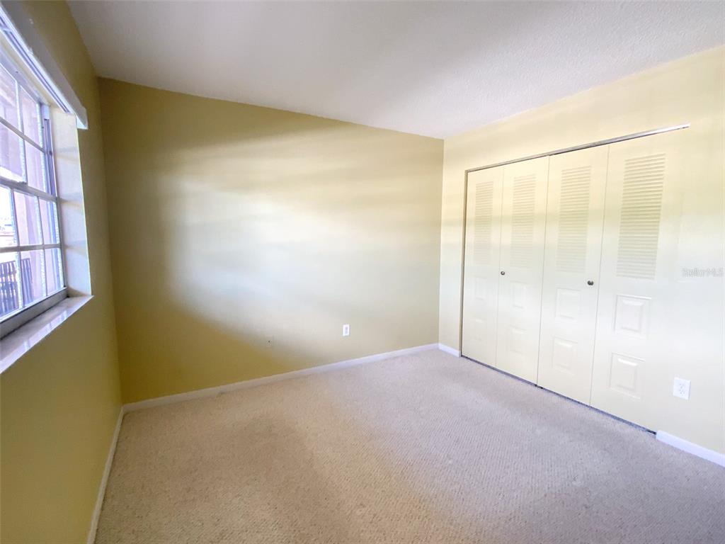 1370 Heather Ridge Boulevard, Unit 204 Dunedin, FL 34698 - Photo 18 of 37 an empty room with a empty space and a window