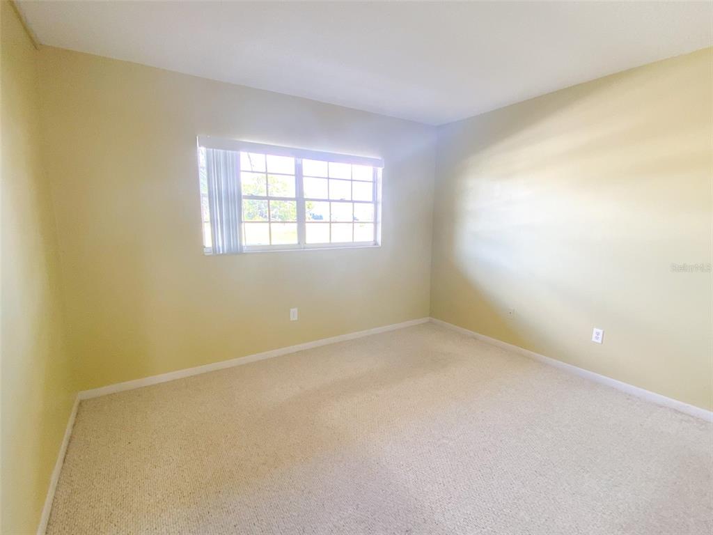 1370 Heather Ridge Boulevard, Unit 204 Dunedin, FL 34698 - Photo 20 of 37 an empty room with a window