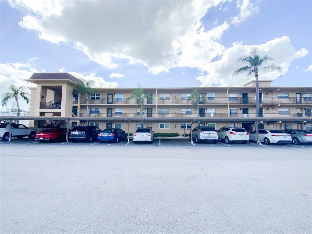 1370 Heather Ridge Boulevard, Unit 204 Dunedin, FL 34698 - Photo 2 of 37 a view of a cars parking space