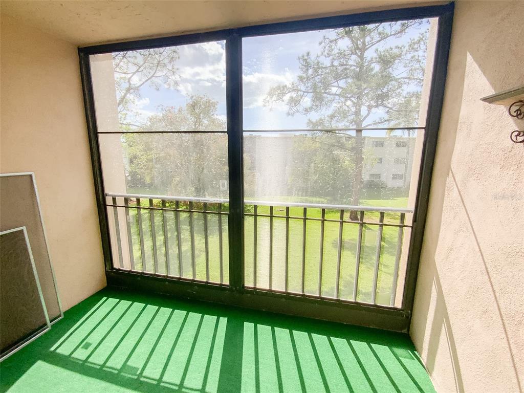 1370 Heather Ridge Boulevard, Unit 204 Dunedin, FL 34698 - Photo 24 of 37 a view of an empty room with a window