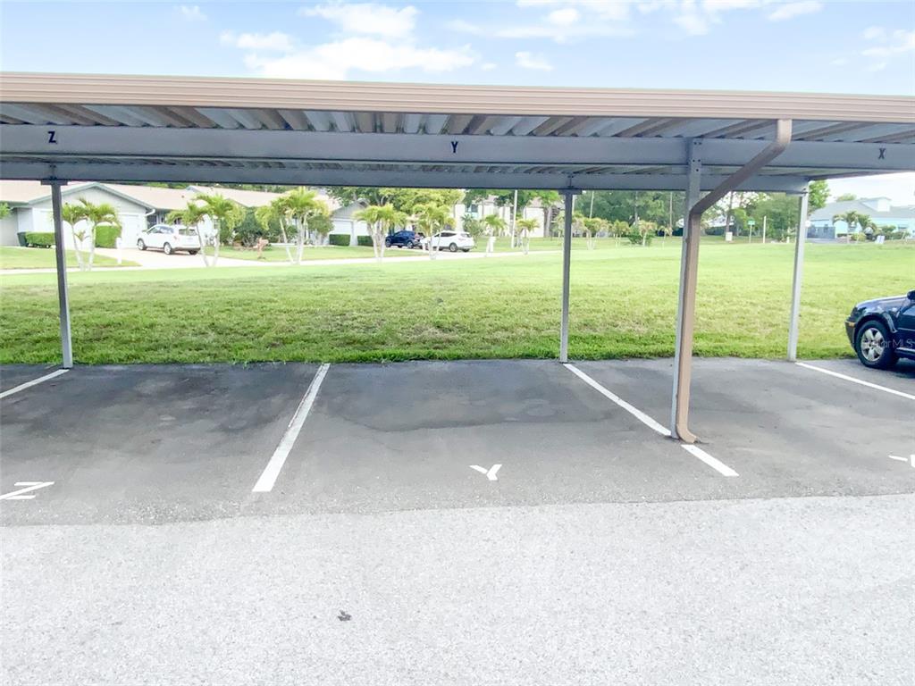 1370 Heather Ridge Boulevard, Unit 204 Dunedin, FL 34698 - Photo 27 of 37 a view of a backyard with a garden and trees