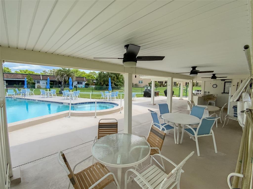 1370 Heather Ridge Boulevard, Unit 204 Dunedin, FL 34698 - Photo 33 of 37 a dining room with furniture and a floor to ceiling window