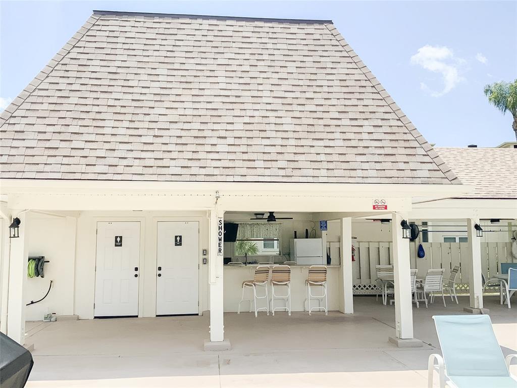 1370 Heather Ridge Boulevard, Unit 204 Dunedin, FL 34698 - Photo 35 of 37 a view of a patio with wooden fence