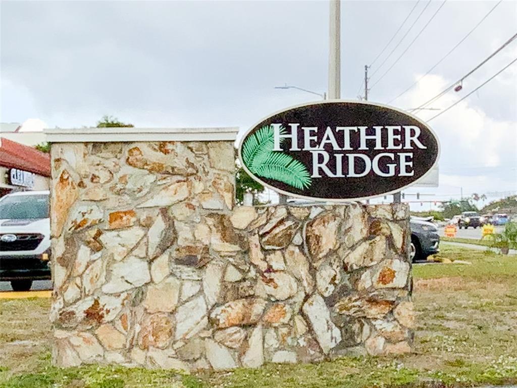 1370 Heather Ridge Boulevard, Unit 204 Dunedin, FL 34698 - Photo 37 of 37 a sign on the side of a building