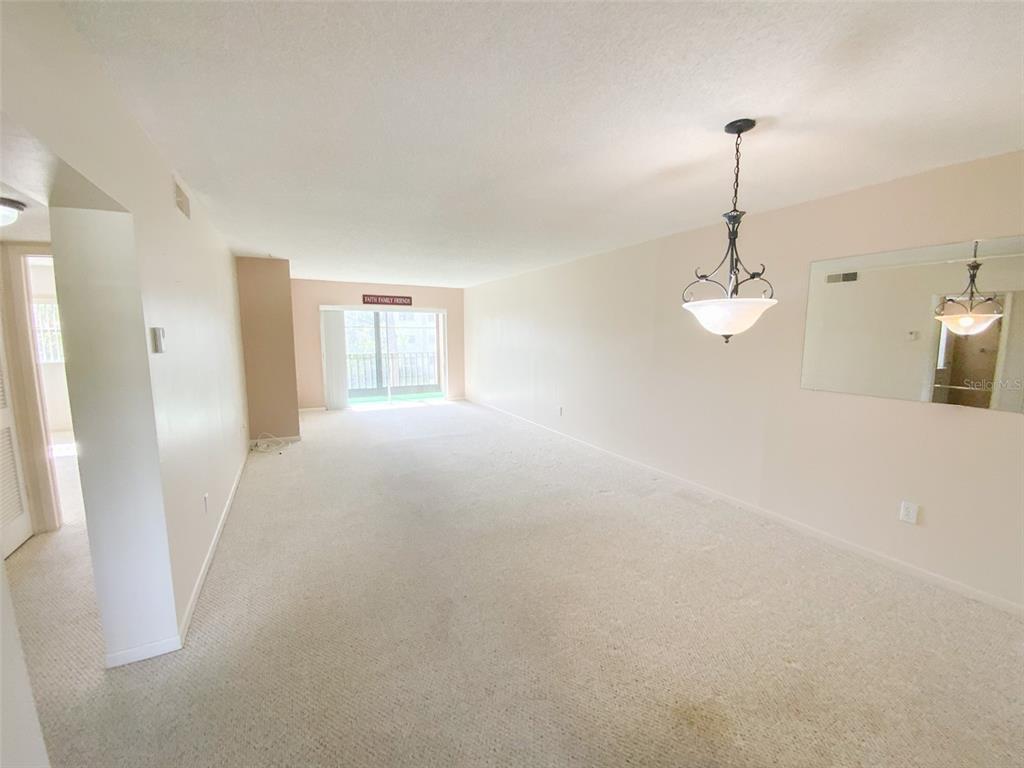 1370 Heather Ridge Boulevard, Unit 204 Dunedin, FL 34698 - Photo 8 of 37 a view of empty room with windows