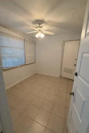 a view of a livingroom with an empty space and a ceiling fan
