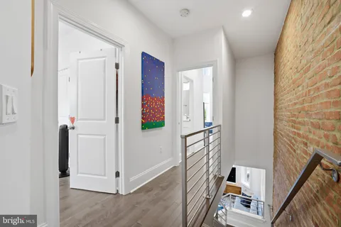 a bedroom with a bed and a flat tv screen on wall